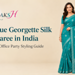 Woman wearing a teal blue georgette silk print saree in India